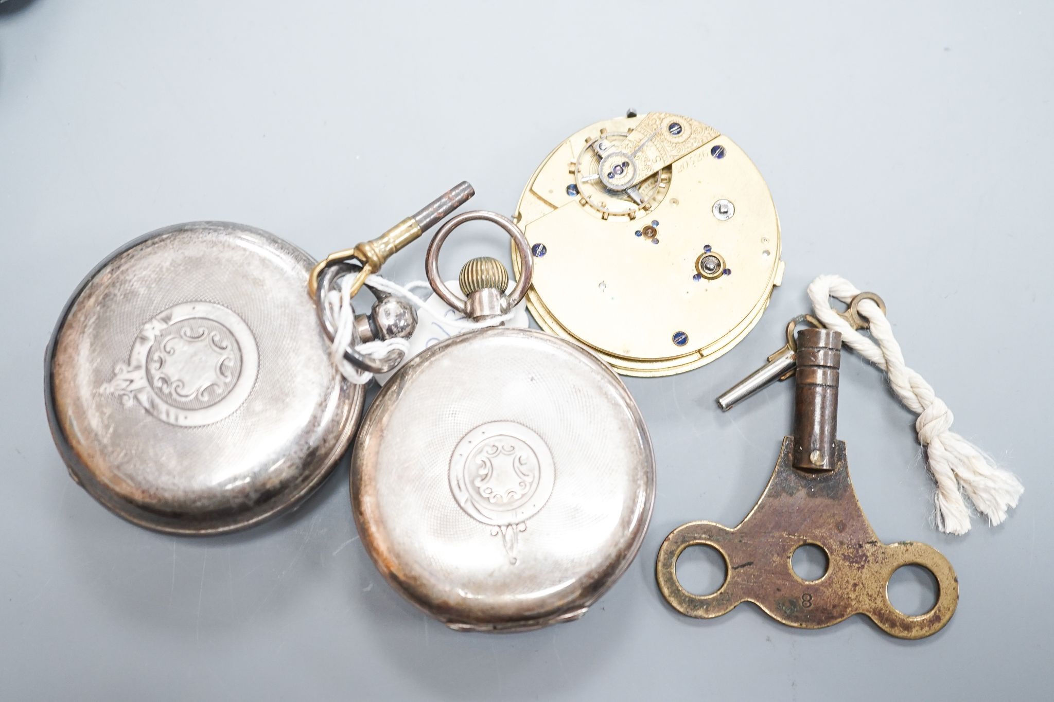 A late Victorian silver keywind open faced pocket watch, retailed by Cornish, Oakehampton, one other silver pocket watch and a pocket watch movement.